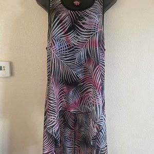 Beautiful Multi colored top . Back hangs long. Beautiful with Pink Boots.